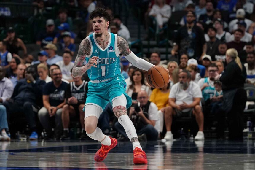 Hornets guard Lamelo Ball brings the ball up court against the Mavericks in the first half of a game at American Airlines Center