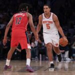 Oct 13, 2025; New York, New York, USA; New York Knicks guard Malcolm Brogdon (5) dribbles against Washington Wizards guard Tre Johnson (12)during the first half at Madison Square Garden. Mandatory Credit: Vincent Carchietta-Imagn Images