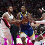 Oct 14, 2025; Portland, Oregon, USA; Golden State Warriors forward Jonathan Kuminga (1) drives to the basket during the first half against Portland Trail Blazers forward Kris Murray (24) at Moda Center. Mandatory Credit: Troy Wayrynen-Imagn Images