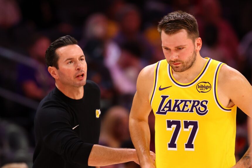 Oct 14, 2025; Phoenix, Arizona, USA; Los Angeles Lakers guard Luka Doncic (77) with head coach JJ Redick against the Phoenix Suns during an NBA preseason game at Mortgage Matchup Center. Mandatory Credit: Mark J. Rebilas-Imagn Images