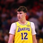 Oct 14, 2025; Phoenix, Arizona, USA; Los Angeles Lakers forward Jake LaRavia (12) against the Phoenix Suns during an NBA preseason game at Mortgage Matchup Center. Mandatory Credit: Mark J. Rebilas-Imagn Images
