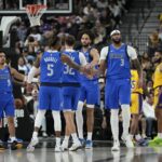 Oct 15, 2025; Las Vegas, Nevada, USA; Dallas Mavericks forward Anthony Davis (3) celebrates with teammates after scoring against the Los Angeles Lakers during the second half at T-Mobile Arena. Mandatory Credit: Lucas Peltier-Imagn Images