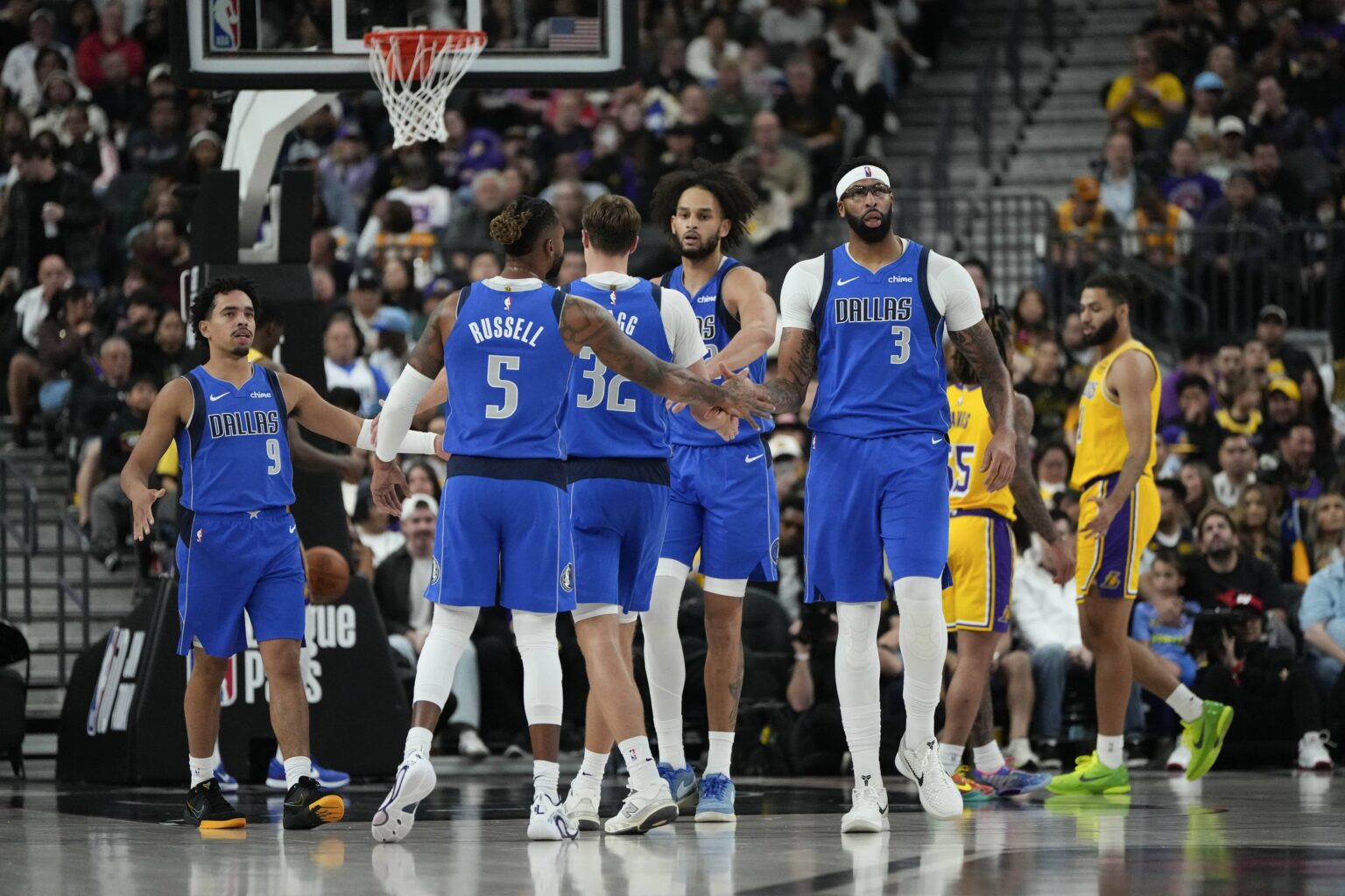 Oct 15, 2025; Las Vegas, Nevada, USA; Dallas Mavericks forward Anthony Davis (3) celebrates with teammates after scoring against the Los Angeles Lakers during the second half at T-Mobile Arena. Mandatory Credit: Lucas Peltier-Imagn Images