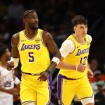Oct 14, 2025; Phoenix, Arizona, USA; Los Angeles Lakers center Deandre Ayton (5) and forward Jake LaRavia (12) against the Phoenix Suns during an NBA preseason game at Mortgage Matchup Center. Mandatory Credit: Mark J. Rebilas-Imagn Images