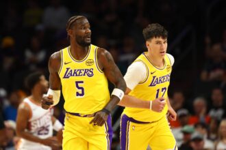 Oct 14, 2025; Phoenix, Arizona, USA; Los Angeles Lakers center Deandre Ayton (5) and forward Jake LaRavia (12) against the Phoenix Suns during an NBA preseason game at Mortgage Matchup Center. Mandatory Credit: Mark J. Rebilas-Imagn Images