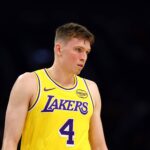 Oct 14, 2025; Phoenix, Arizona, USA; Los Angeles Lakers guard Dalton Knecht (4) against the Phoenix Suns during an NBA preseason game at Mortgage Matchup Center. Mandatory Credit: Mark J. Rebilas-Imagn Images