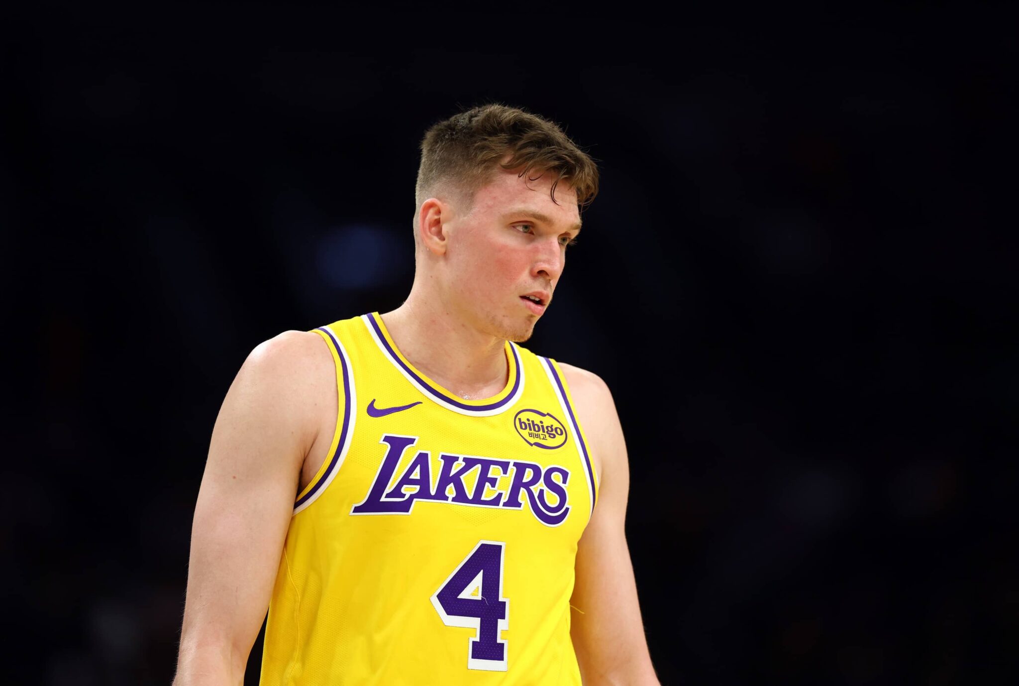 Oct 14, 2025; Phoenix, Arizona, USA; Los Angeles Lakers guard Dalton Knecht (4) against the Phoenix Suns during an NBA preseason game at Mortgage Matchup Center. Mandatory Credit: Mark J. Rebilas-Imagn Images