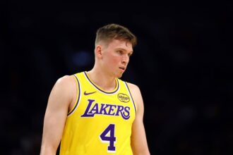 Oct 14, 2025; Phoenix, Arizona, USA; Los Angeles Lakers guard Dalton Knecht (4) against the Phoenix Suns during an NBA preseason game at Mortgage Matchup Center. Mandatory Credit: Mark J. Rebilas-Imagn Images