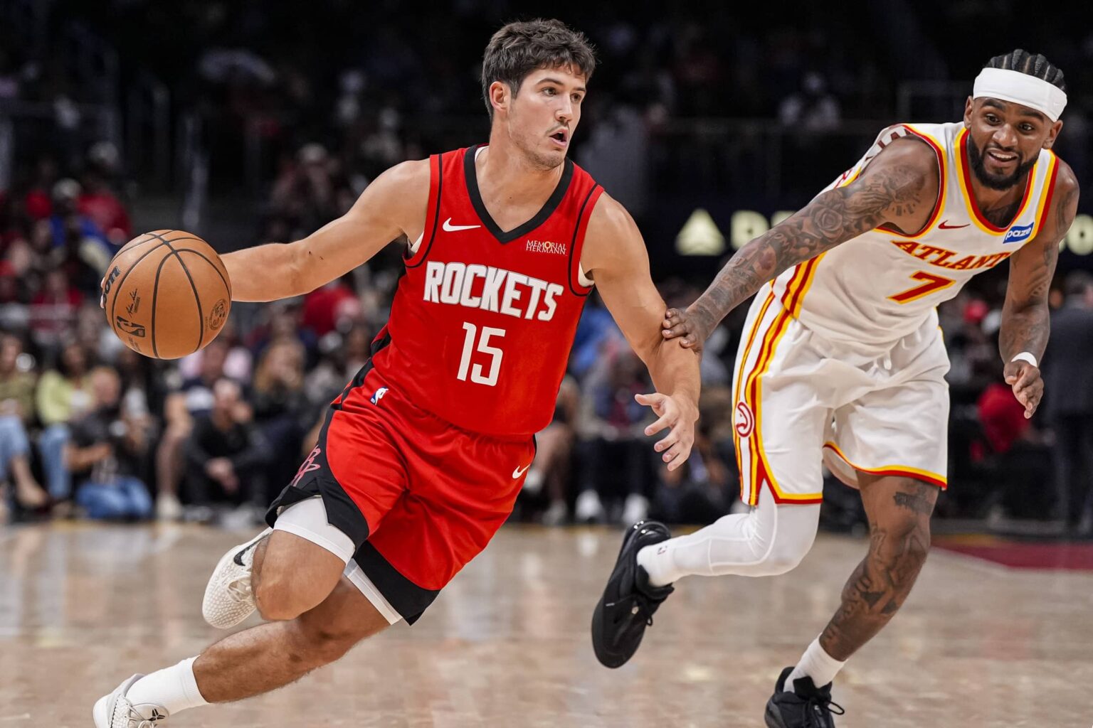 Oct 16, 2025; Atlanta, Georgia, USA; Houston Rockets guard Reed Sheppard (15) dribbles past Atlanta Hawks guard Nickeil Alexander-Walker (7) during the second half at State Farm Arena. Mandatory Credit: Dale Zanine-Imagn Images