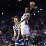 Oct 17, 2025; Philadelphia, Pennsylvania, USA; Philadelphia 76ers guard Vj Edgecombe (77) is fouled by Minnesota Timberwolves guard Jules Bernard (14) while driving for a dunk during the fourth quarter at Xfinity Mobile Arena. Mandatory Credit: Bill Streicher-Imagn Images