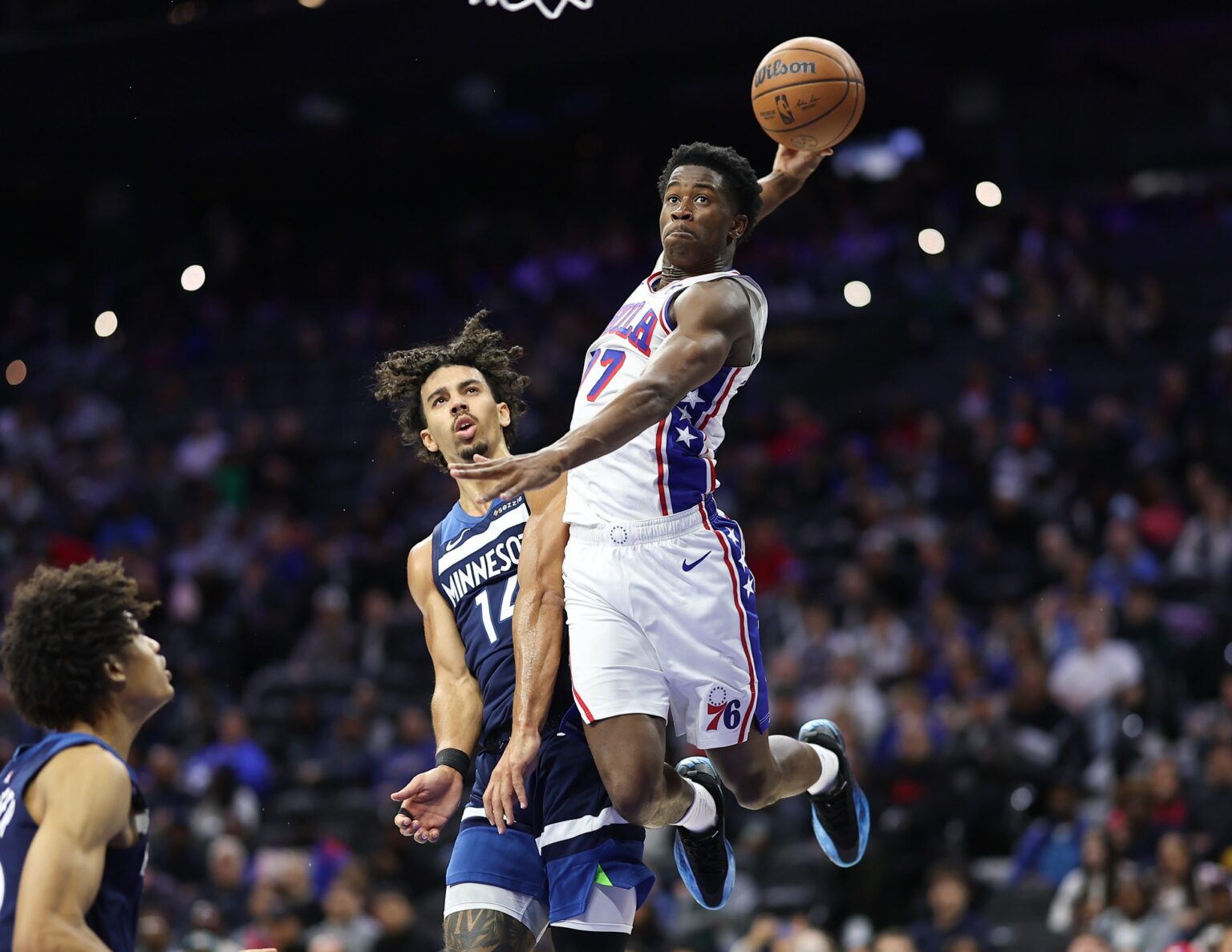 Oct 17, 2025; Philadelphia, Pennsylvania, USA; Philadelphia 76ers guard Vj Edgecombe (77) is fouled by Minnesota Timberwolves guard Jules Bernard (14) while driving for a dunk during the fourth quarter at Xfinity Mobile Arena. Mandatory Credit: Bill Streicher-Imagn Images