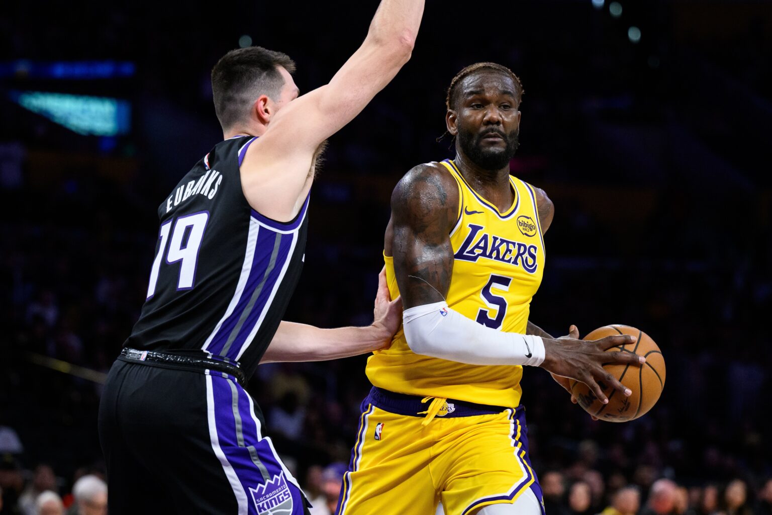 Oct 17, 2025; Los Angeles, California, USA; Los Angeles Lakers center Deandre Ayton (5) drives the ball against Sacramento Kings forward/center Drew Eubanks (19) during the second half at Crypto.com Arena. Mandatory Credit: William Liang-Imagn Images