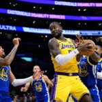 Oct 21, 2025; Los Angeles, California, USA; Los Angeles Lakers center Deandre Ayton (5) grabs a rebound against Golden State Warriors guard Gary Payton II (0) during the first half at Crypto.com Arena. Mandatory Credit: William Liang-Imagn Images