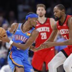 Oct 21, 2025; Oklahoma City, Oklahoma, USA; Oklahoma City Thunder guard Shai Gilgeous-Alexander (2) keeps the ball away from Houston Rockets forward Kevin Durant (7) during the second half at Paycom Center. Mandatory Credit: Alonzo Adams-Imagn Images