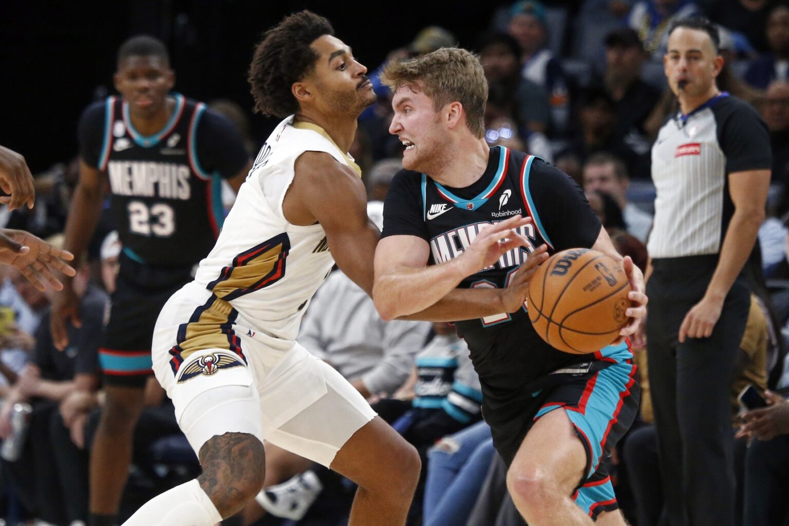 Oct 22, 2025; Memphis, Tennessee, USA; Memphis Grizzlies guard Cam Spencer (24) handles the ball as New Orleans Pelicans guard Jordan Poole (3) defends during the fourth quarter at FedExForum. Mandatory Credit: Petre Thomas-Imagn Images