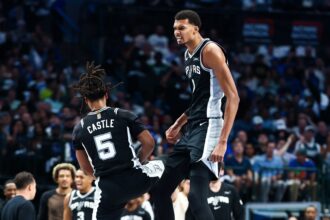Oct 22, 2025; Dallas, Texas, USA; San Antonio Spurs forward Victor Wembanyama (1) celebrates with San Antonio Spurs guard Stephon Castle (5) during the first half against the Dallas Mavericks at American Airlines Center. Mandatory Credit: Kevin Jairaj-Imagn Images