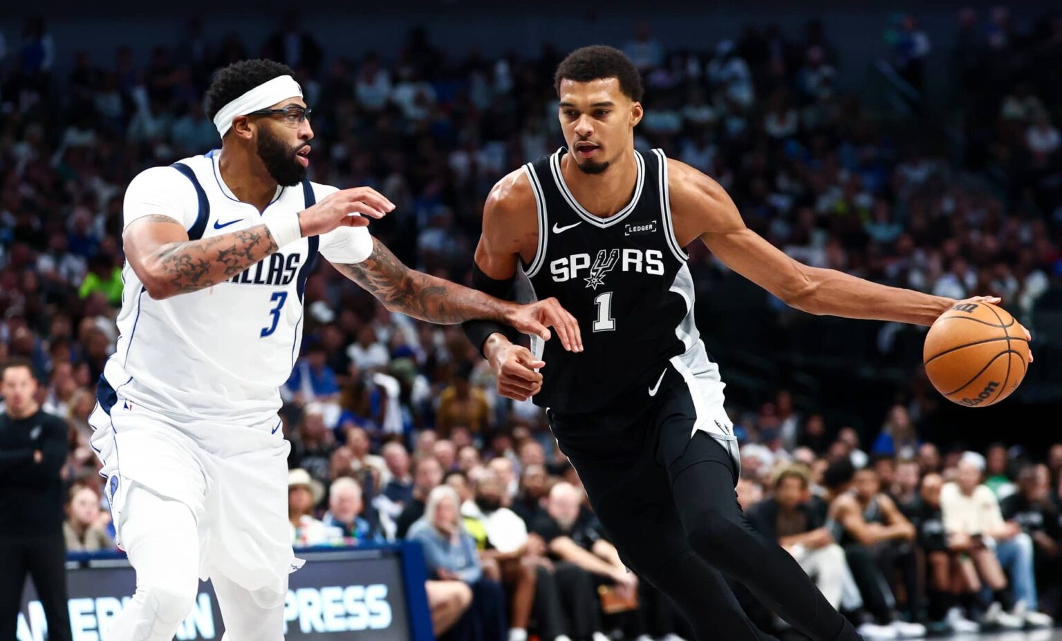 Oct 22, 2025; Dallas, Texas, USA; San Antonio Spurs forward Victor Wembanyama (1) drives to the basket as Dallas Mavericks forward Anthony Davis (3) defends during the second half at American Airlines Center. Mandatory Credit: Kevin Jairaj-Imagn Images