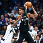 Oct 22, 2025; Dallas, Texas, USA; San Antonio Spurs forward Victor Wembanyama (1) looks to score as Dallas Mavericks forward Naji Marshall (13) defends during the first half at American Airlines Center. Mandatory Credit: Kevin Jairaj-Imagn Images