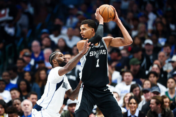 Oct 22, 2025; Dallas, Texas, USA; San Antonio Spurs forward Victor Wembanyama (1) looks to score as Dallas Mavericks forward Naji Marshall (13) defends during the first half at American Airlines Center. Mandatory Credit: Kevin Jairaj-Imagn Images