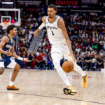 Oct 24, 2025; New Orleans, Louisiana, USA; San Antonio Spurs forward/center Victor Wembanyama (1) dribbles against New Orleans Pelicans guard Jordan Poole (3) during the first half at Smoothie King Center. Mandatory Credit: Stephen Lew-Imagn Images