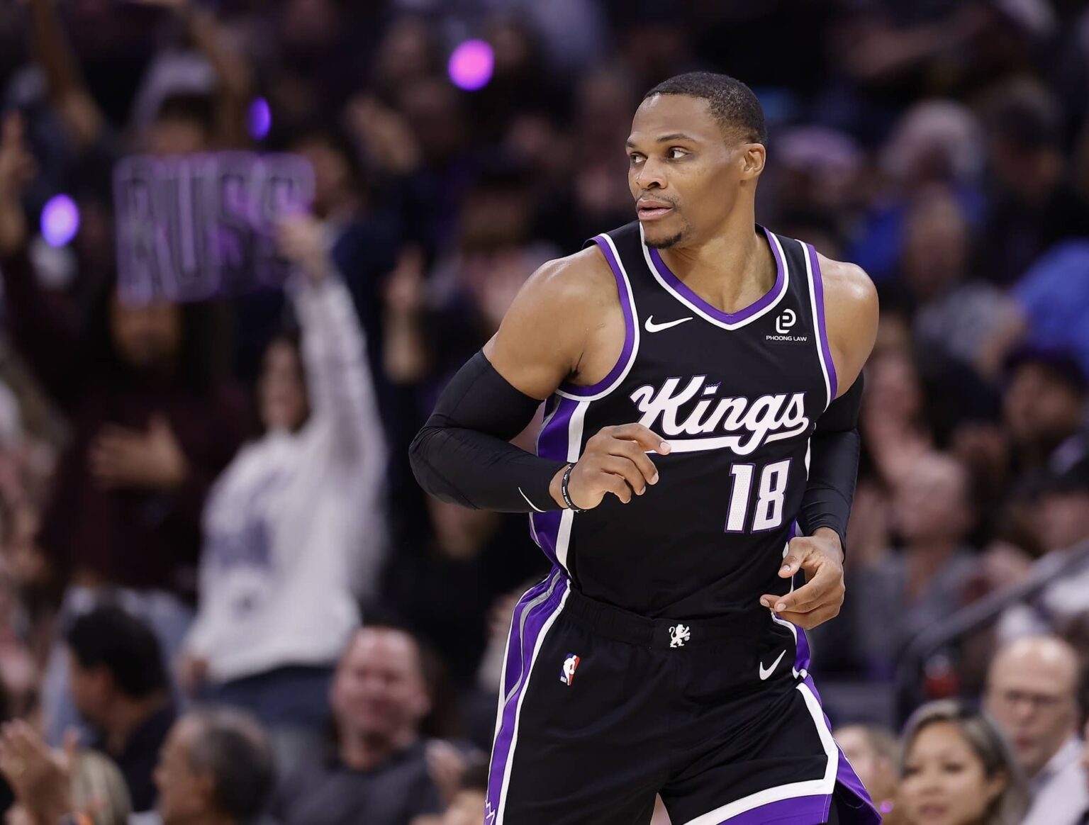 Oct 24, 2025; Sacramento, California, USA; A Sacramento Kings fan holds a sign reading “Russ” after guard Russell Westbrook (18) scores a three point basket against the Utah Jazz during the fourth quarter at Golden 1 Center. Mandatory Credit: Kelley L Cox-Imagn Images