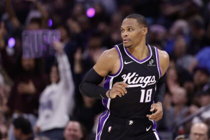 Oct 24, 2025; Sacramento, California, USA; A Sacramento Kings fan holds a sign reading “Russ” after guard Russell Westbrook (18) scores a three point basket against the Utah Jazz during the fourth quarter at Golden 1 Center. Mandatory Credit: Kelley L Cox-Imagn Images