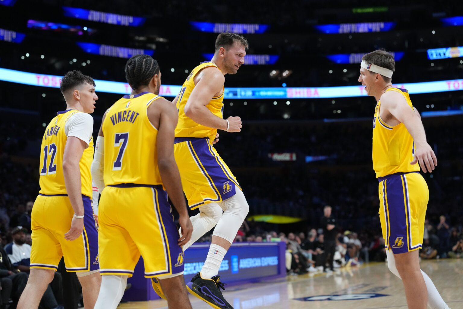 Oct 24, 2025; Los Angeles, California, USA; Los Angeles Lakers guard Luka Doncic (77) celebrates with forward Jake LaRavia (12), guard Gabe Vincent (7) and guard Austin Reaves (15) in the second half against the Minnesota Timberwolves at Crypto.com Arena. Mandatory Credit: Kirby Lee-Imagn Images