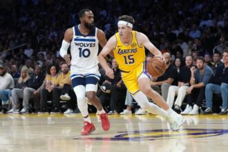 Oct 24, 2025; Los Angeles, California, USA; Los Angeles Lakers guard Austin Reaves (15) dribbles the ball against Minnesota Timberwolves guard Mike Conley (10) in the second half at Crypto.com Arena. Mandatory Credit: Kirby Lee-Imagn Images