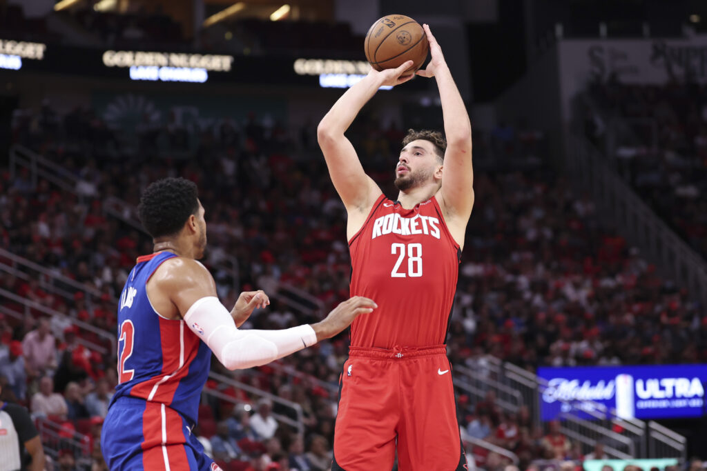 Oct 24, 2025; Houston, Texas, USA; Houston Rockets center Alperen Sengun (28) shoots the ball as Detroit Pistons forward Tobias Harris (12) defends during the first quarter at Toyota Center. Mandatory Credit: Troy Taormina-Imagn Images