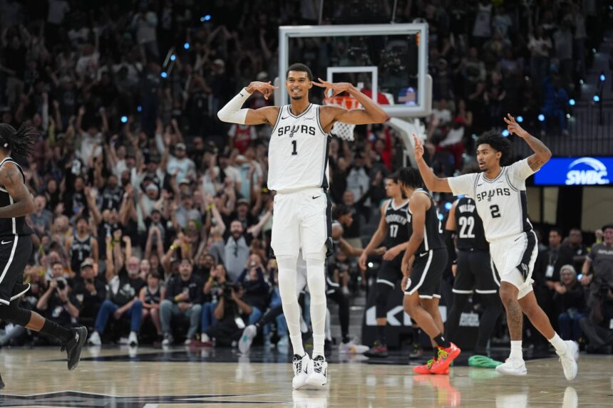 Oct 26, 2025; San Antonio, Texas, USA; San Antonio Spurs forward Victor Wembanyama (1) celebrates a three-point shot in the second half against the Brooklyn Nets at Frost Bank Center. Mandatory Credit: Daniel Dunn-Imagn Images