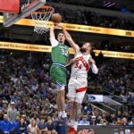 Oct 26, 2025; Dallas, Texas, USA; Dallas Mavericks forward Cooper Flagg (32) dunks the ball past Toronto Raptors forward Sandro Mamukelashvili (54) during the third quarter at the American Airlines Center. Mandatory Credit: Jerome Miron-Imagn Images