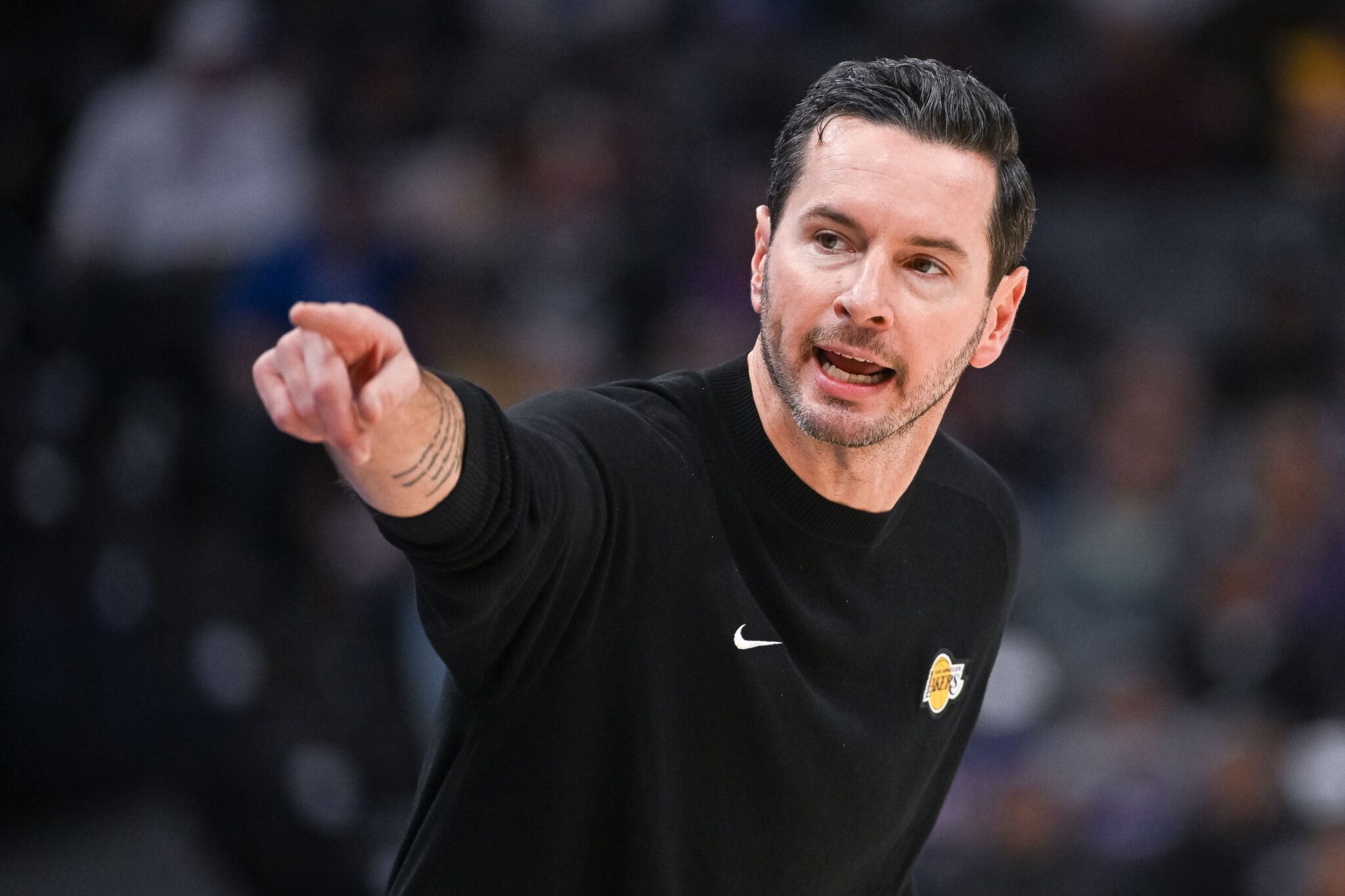 Oct 26, 2025; Sacramento, California, USA; Los Angeles Lakers head coach JJ Redick makes a call to the bench during the first quarter of the game against the Sacramento Kings at Golden 1 Center. Mandatory Credit: Ed Szczepanski-Imagn Images