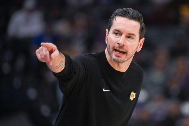 Oct 26, 2025; Sacramento, California, USA; Los Angeles Lakers head coach JJ Redick makes a call to the bench during the first quarter of the game against the Sacramento Kings at Golden 1 Center. Mandatory Credit: Ed Szczepanski-Imagn Images