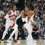 Oct 27, 2025; San Antonio, Texas, USA; San Antonio Spurs forward/center Victor Wembanyama (1) looks to pass in front of Toronto Raptors forward Collin Murray-Boyles (12) in the second half at Frost Bank Center. Mandatory Credit: Daniel Dunn-Imagn Images