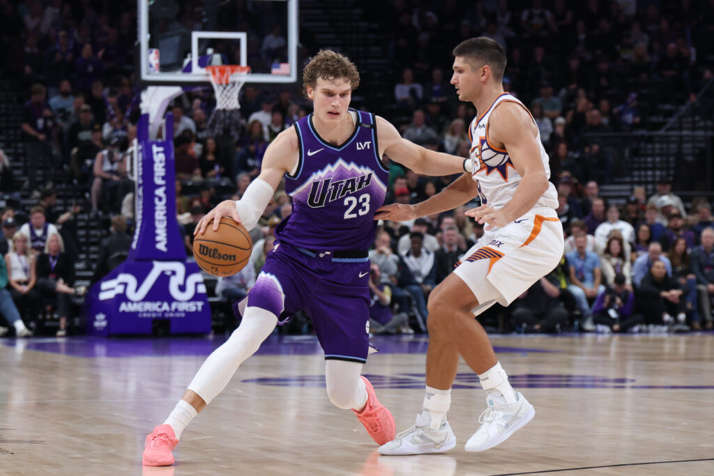 Oct 27, 2025; Salt Lake City, Utah, USA; Utah Jazz forward Lauri Markkanen (23) dribbles against Phoenix Suns guard Grayson Allen (8) during overtime at Delta Center. Mandatory Credit: Rob Gray-Imagn Images