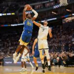 Oct 27, 2025; San Francisco, California, USA; Golden State Warriors forward Jonathan Kuminga (1) dunks the ball over Memphis Grizzlies forward Santi Aldama (7) in the fourth quarter at the Chase Center. Mandatory Credit: Cary Edmondson-Imagn Images