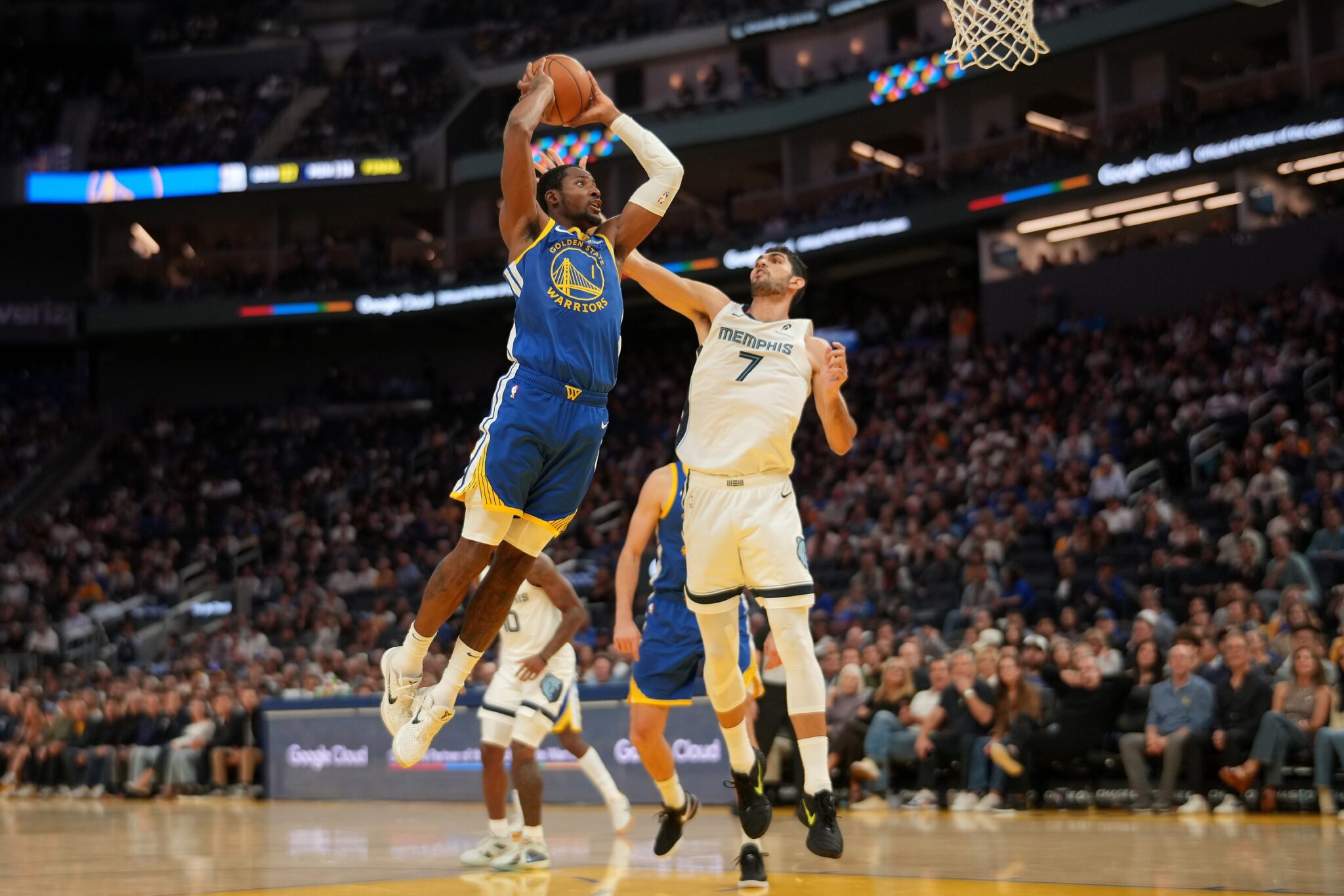 Oct 27, 2025; San Francisco, California, USA; Golden State Warriors forward Jonathan Kuminga (1) dunks the ball over Memphis Grizzlies forward Santi Aldama (7) in the fourth quarter at the Chase Center. Mandatory Credit: Cary Edmondson-Imagn Images