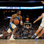 Oct 27, 2025; San Francisco, California, USA; Golden State Warriors forward Jonathan Kuminga (1) dribbles the ball next to Memphis Grizzlies center Jock Landale (31) in the fourth quarter at the Chase Center. Mandatory Credit: Cary Edmondson-Imagn Images