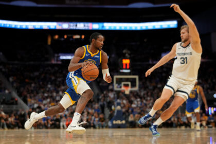 Oct 27, 2025; San Francisco, California, USA; Golden State Warriors forward Jonathan Kuminga (1) dribbles the ball next to Memphis Grizzlies center Jock Landale (31) in the fourth quarter at the Chase Center. Mandatory Credit: Cary Edmondson-Imagn Images