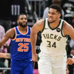 Oct 28, 2025; Milwaukee, Wisconsin, USA; Milwaukee Bucks forward Giannis Antetokounmpo (34) reacts after scoring a basket in the 3rd quarter as New York Knicks guard Mikal Bridges (25) looks on at Fiserv Forum. Mandatory Credit: Benny Sieu-Imagn Images