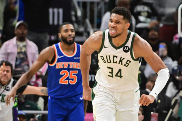 Oct 28, 2025; Milwaukee, Wisconsin, USA; Milwaukee Bucks forward Giannis Antetokounmpo (34) reacts after scoring a basket in the 3rd quarter as New York Knicks guard Mikal Bridges (25) looks on at Fiserv Forum. Mandatory Credit: Benny Sieu-Imagn Images
