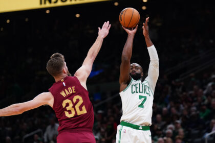 Oct 29, 2025; Boston, Massachusetts, USA; Boston Celtics guard/forward Jaylen Brown (7) shoots the ball against Cleveland Cavaliers forward/center Dean Wade (32) in the last seconds of the second quarter at TD Garden. Mandatory Credit: David Butler II-Imagn Images