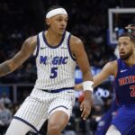 Oct 29, 2025; Detroit, Michigan, USA; Orlando Magic forward Paolo Banchero (5) dribbles while defended by Detroit Pistons guard Cade Cunningham (2) in the first half at Little Caesars Arena. Mandatory Credit: Rick Osentoski-Imagn Images