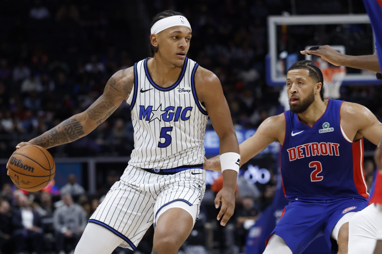 Oct 29, 2025; Detroit, Michigan, USA; Orlando Magic forward Paolo Banchero (5) dribbles while defended by Detroit Pistons guard Cade Cunningham (2) in the first half at Little Caesars Arena. Mandatory Credit: Rick Osentoski-Imagn Images