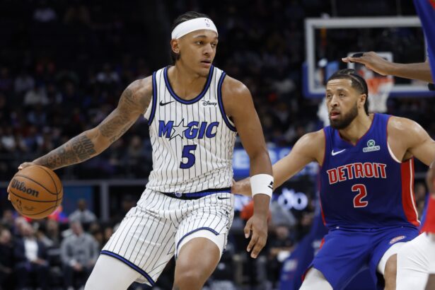 Oct 29, 2025; Detroit, Michigan, USA; Orlando Magic forward Paolo Banchero (5) dribbles while defended by Detroit Pistons guard Cade Cunningham (2) in the first half at Little Caesars Arena. Mandatory Credit: Rick Osentoski-Imagn Images