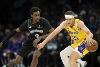 Oct 29, 2025; Minneapolis, Minnesota, USA; Los Angeles Lakers guard Austin Reaves (15) dribbles the ball as Minnesota Timberwolves forward Jaden McDaniels (3) plays defense in the first half at Target Center. Mandatory Credit: Jesse Johnson-Imagn Images