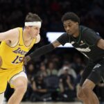 Oct 29, 2025; Minneapolis, Minnesota, USA; Los Angeles Lakers guard Austin Reaves (15) dribbles the ball past Minnesota Timberwolves forward Jaden McDaniels (3) in the second half at Target Center. Mandatory Credit: Jesse Johnson-Imagn Images