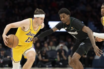 Oct 29, 2025; Minneapolis, Minnesota, USA; Los Angeles Lakers guard Austin Reaves (15) dribbles the ball past Minnesota Timberwolves forward Jaden McDaniels (3) in the second half at Target Center. Mandatory Credit: Jesse Johnson-Imagn Images