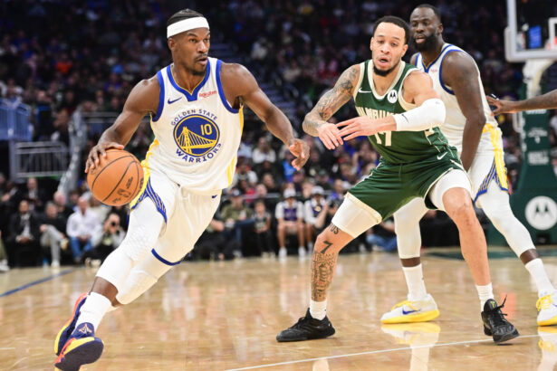 Oct 30, 2025; Milwaukee, Wisconsin, USA; Golden State Warriors forward Jimmy Butler (10) drives for the basket against Milwaukee Bucks forward Amir Coffey (17) in the second quarter at Fiserv Forum. Mandatory Credit: Benny Sieu-Imagn Images