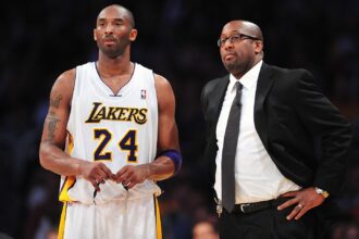 March 11, 2012; Los Angeles, CA, USA; Los Angeles Lakers shooting guard Kobe Bryant (24) and head coach Mike Brown during a stoppage in play against the Boston Celtics during the second half at Staples Center. Mandatory Credit: Gary A. Vasquez-USA TODAY Sports